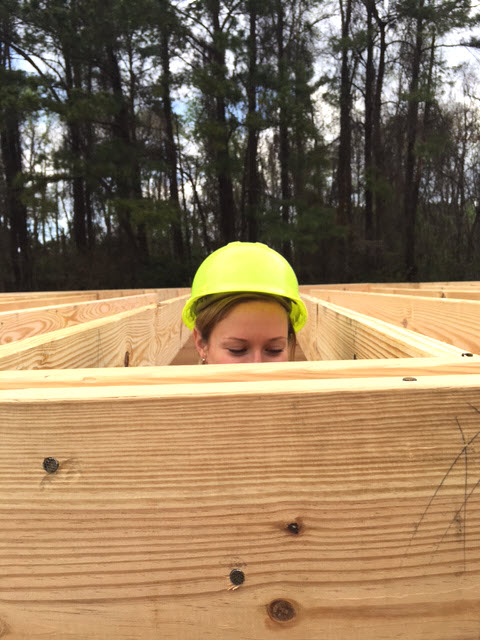 Laura peeks at the wooden boards.