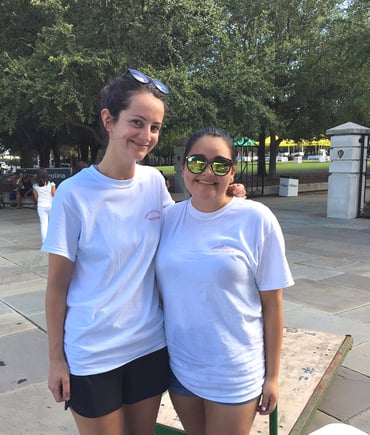 Two women smile at the camera.