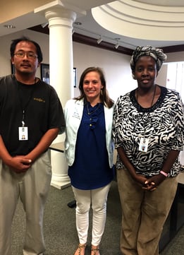 Three individuals (two math instructors and a Hawkes training representative) pose for a picture during a campus visit.