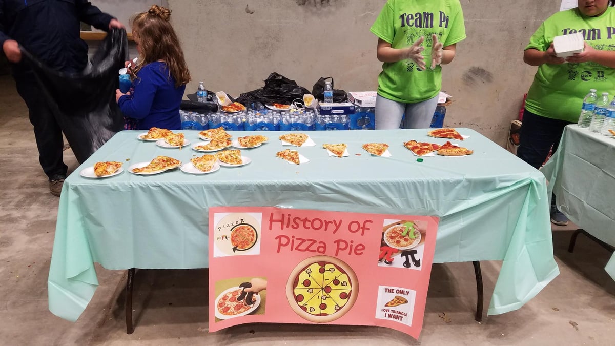 A pizza pie booth contained refreshments of pizza slices for attendees.