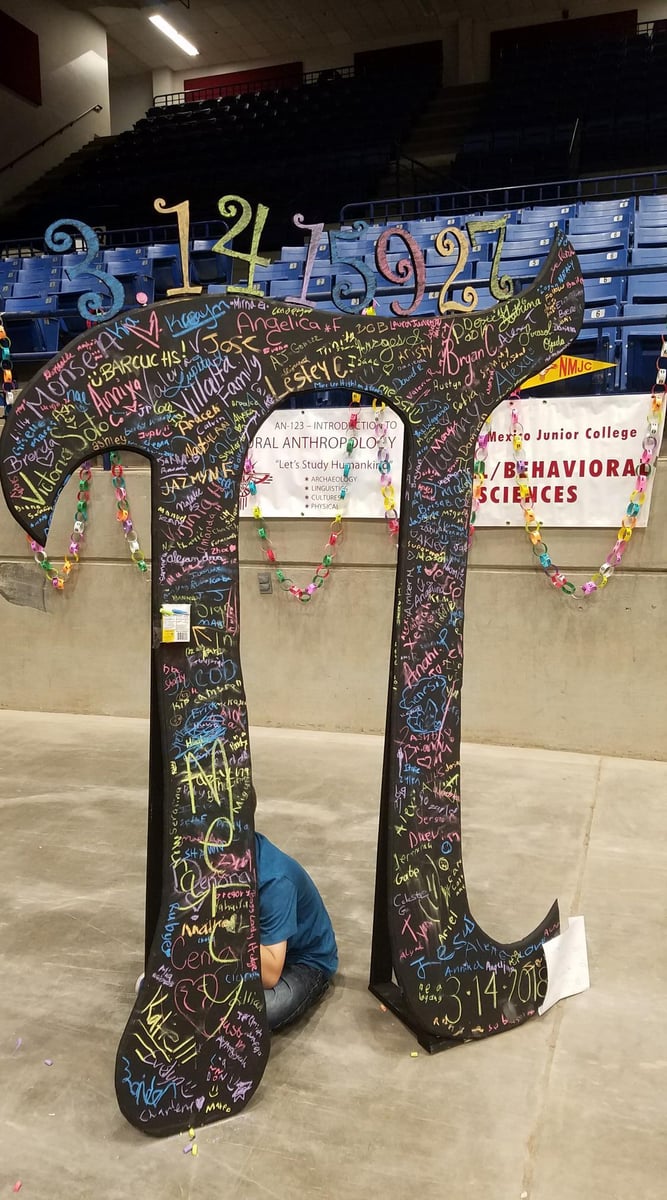 A giant Pi symbol has names written all over it.