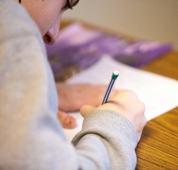 student-writing-on-paper