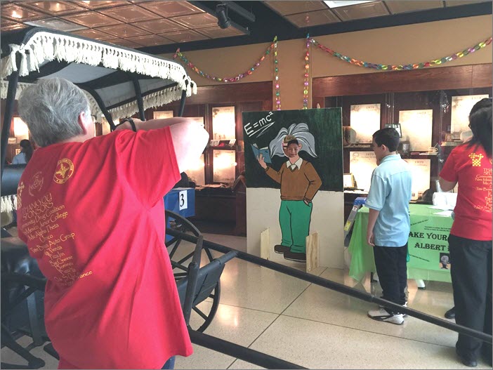 A child gets his picture taken as Albert Einstein.